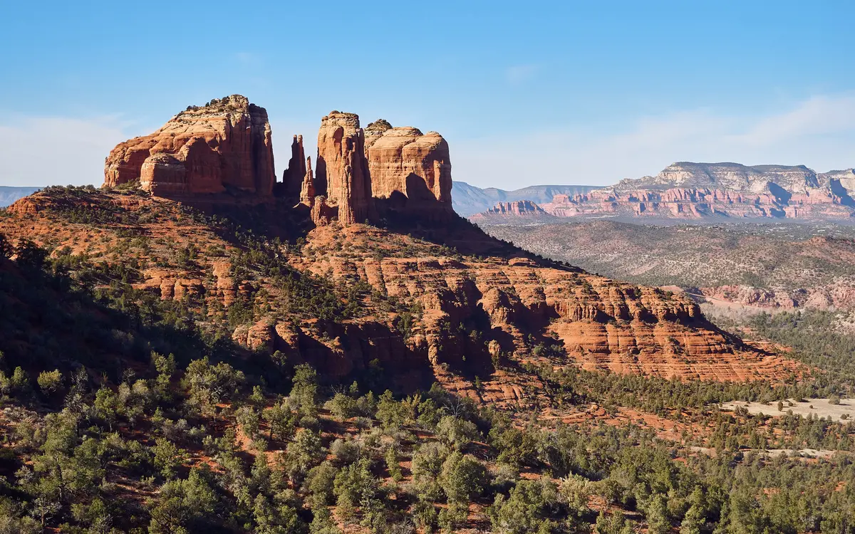 Red sandstone spires of Cathedral Rock rising against a blue sky near Sedona, Arizona