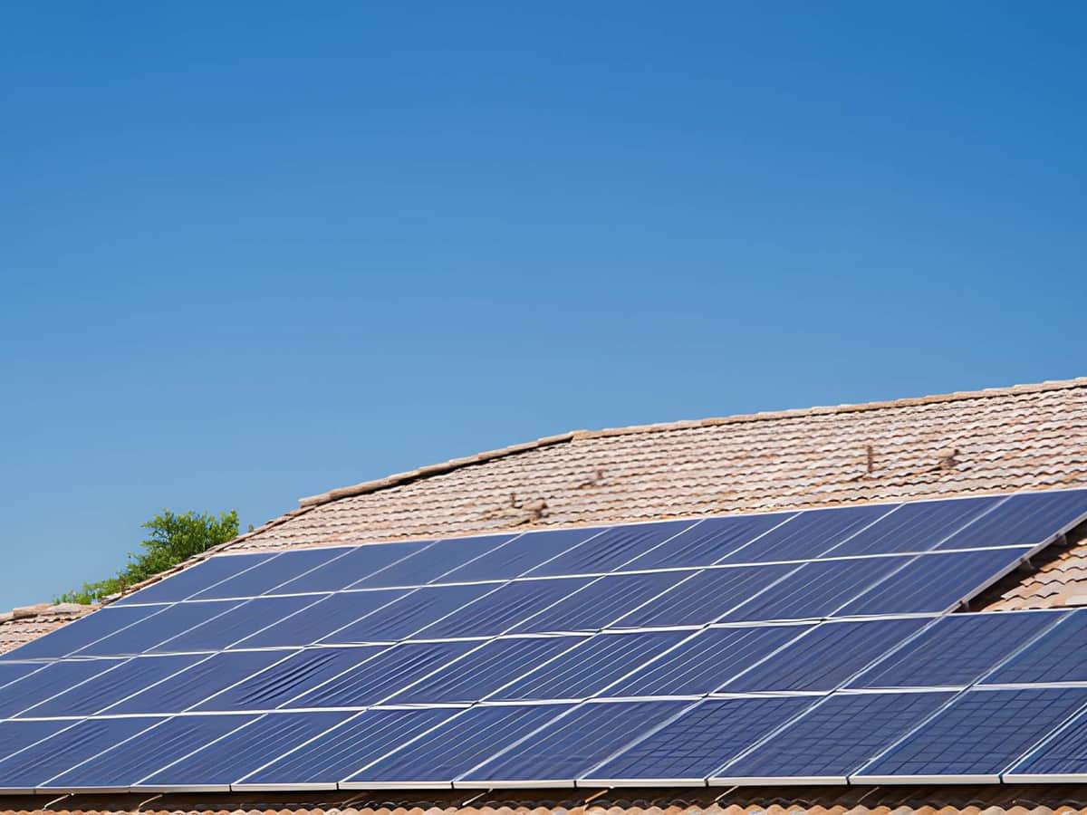 Clean rooftop solar panel array on an Arizona home under a clear morning sky